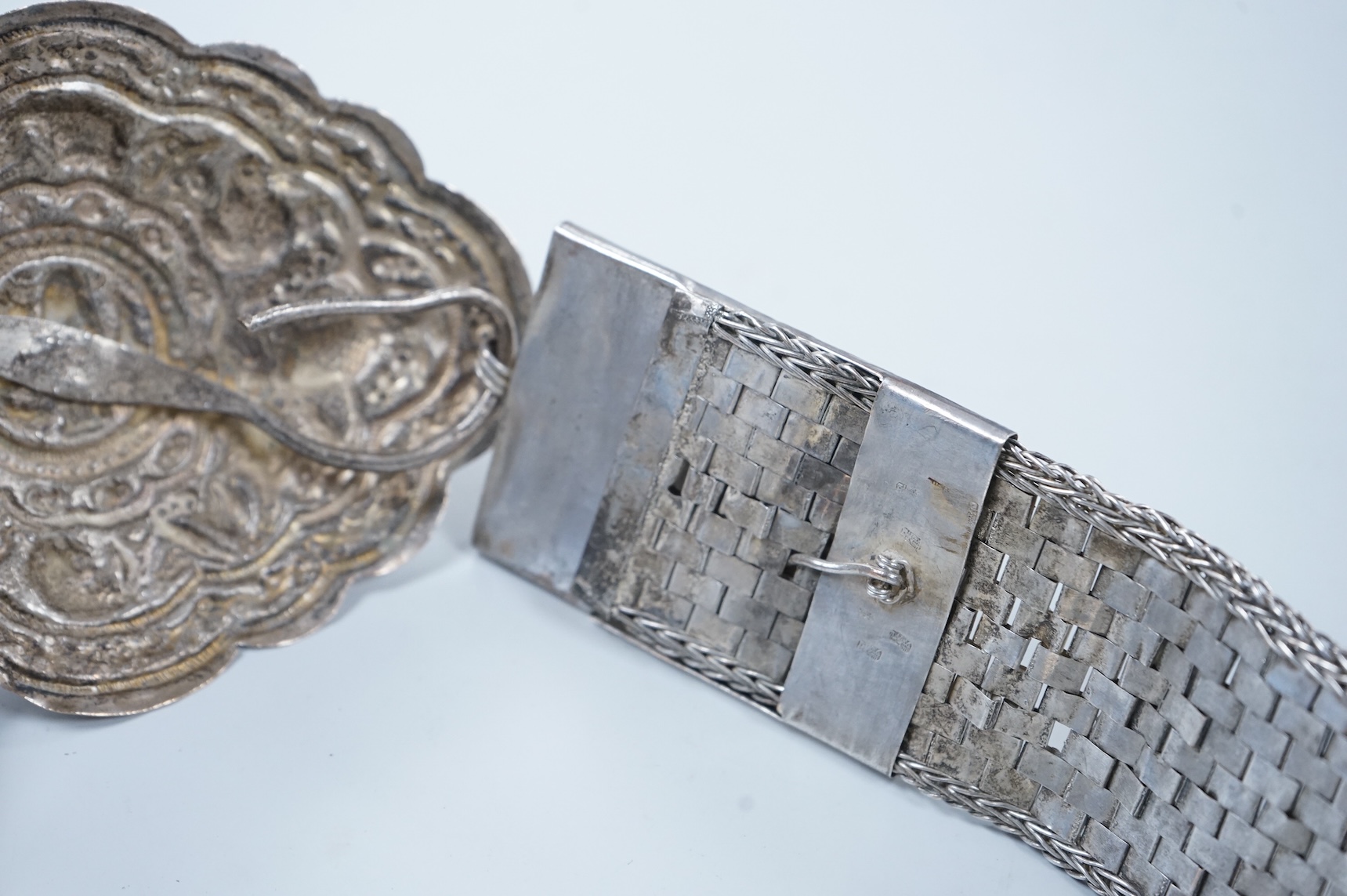 An early 20th century Chinese Straits repoussé white metal belt and buckle, stamped marks, 273g